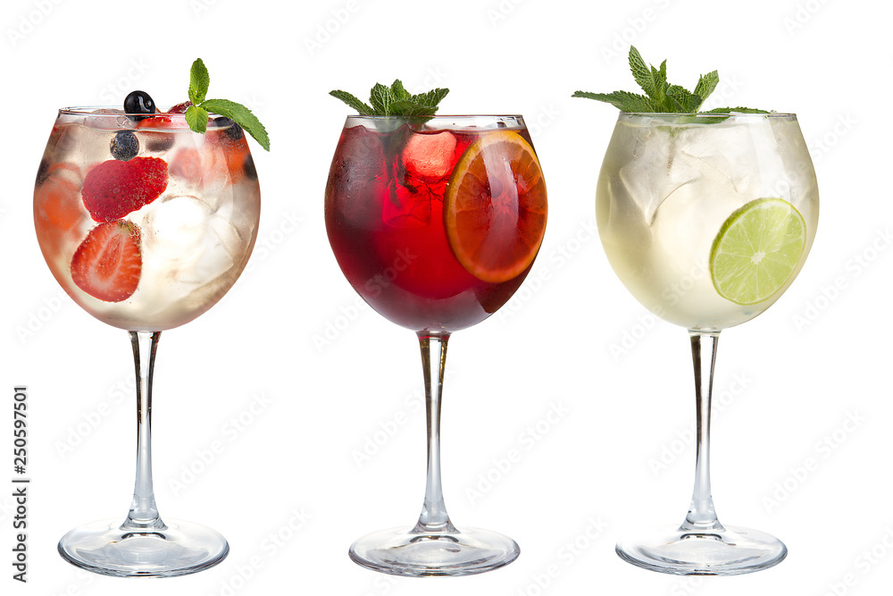 Alcohol refreshing cocktails with mint, fruits and berries on a white background. Set of three cocktails in glass goblets. Alcohol refreshing cocktails with mint, fruits and berries on a white background. Set of three cocktails in glass goblets.