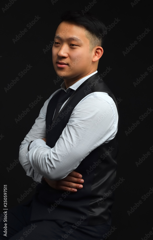 Photo of an Asian man standing on a black background Photo of an Asian man standing on a black background