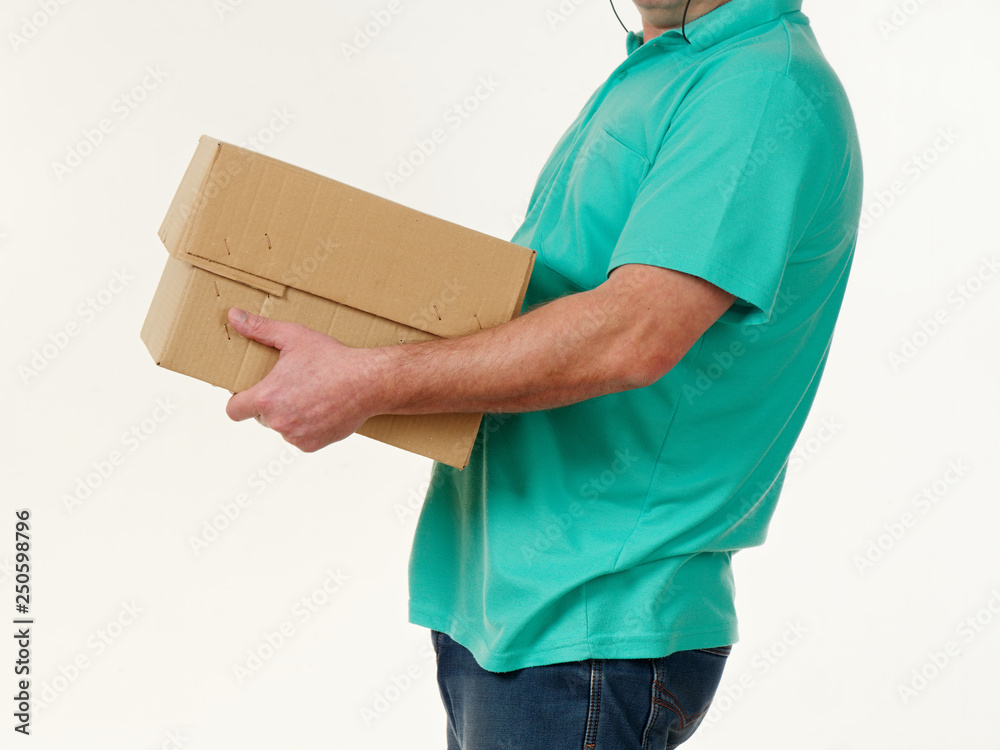 man holds in his hands a big box on a white background.