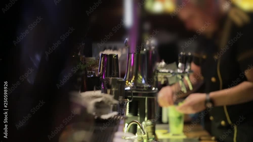 Barman makes alcoholic drink with fruits on the bar counter. Professional equipment. Bartender makes fresh. Barman makes alcoholic drink with fruits on the bar counter. Professional equipment. Bartender makes fresh.