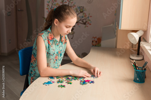 Cute little girl solving puzzle together