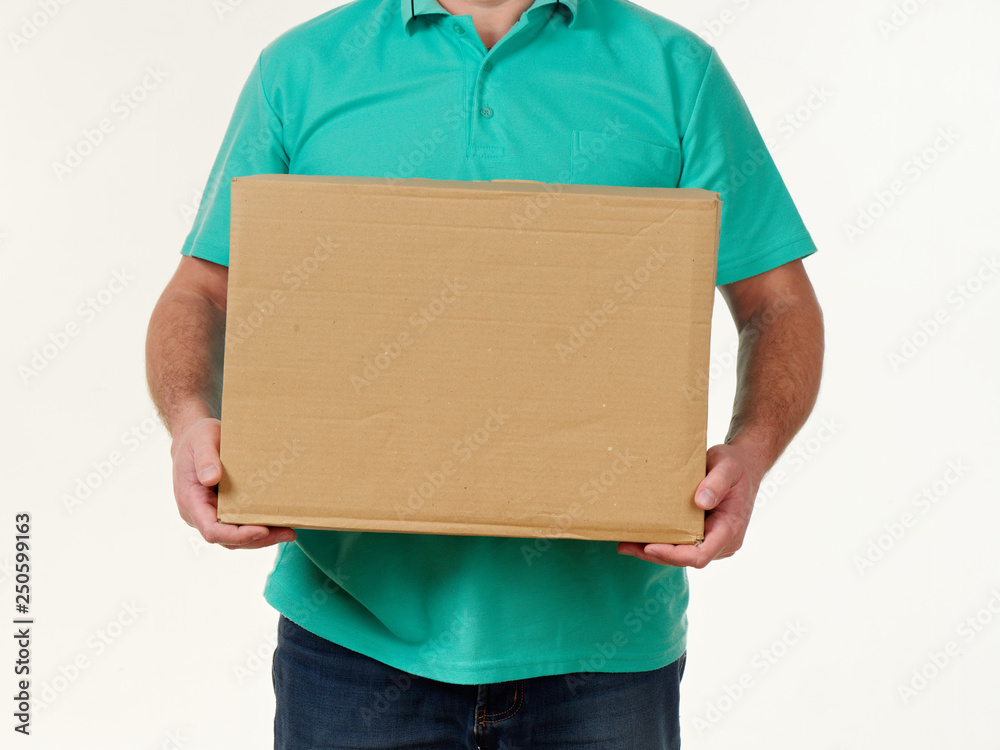 man holds in his hands a big box on a white background. man holds in his hands a big box on a white background.