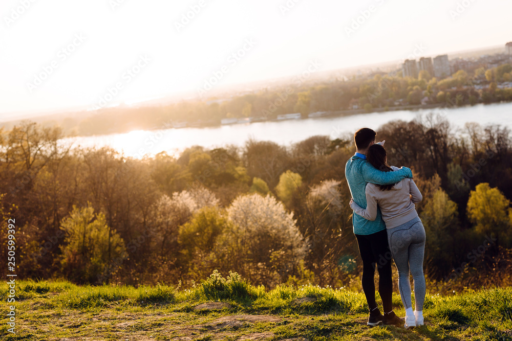 Happy young sporty couple sharing romantic moments Happy young sporty couple sharing romantic moments