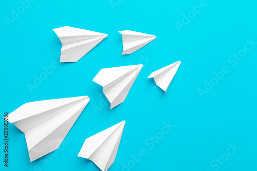 white paper airplane on a blue background