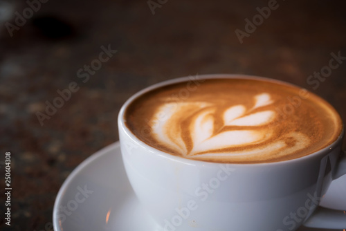 Cup of Latte on the table in coffee shop background