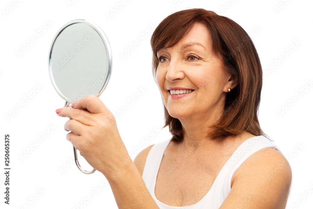 beauty and old people concept - portrait of smiling senior woman with mirror over white background beauty and old people concept - portrait of smiling senior woman with mirror over white background