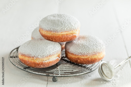 Sweet and brown donuts with powdered sugar