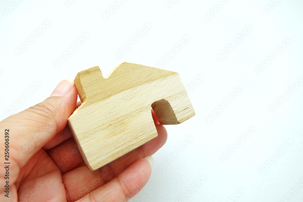 Close up of mini house on woman hand and white background