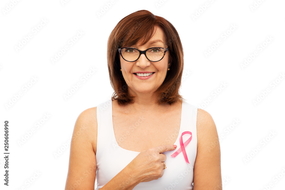 health, charity and old people concept - portrait of smiling senior woman in glasses with pink breast cancer awareness ribbon over white background health, charity and old people concept - portrait of smiling senior woman in glasses with pink breast cancer awareness ribbon over white background