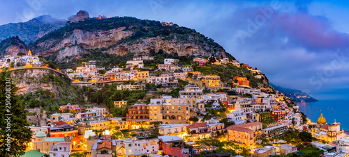 Panoramic sunset view of colorful buildings in Positano at Amalfi Coast, Italy.