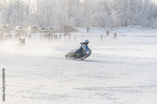 Winter motocross, Driver with motorcycle photo