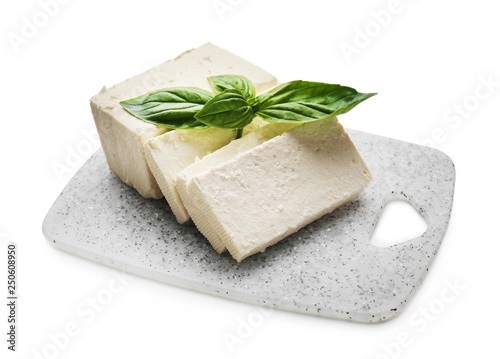 Board with tasty feta cheese on white background