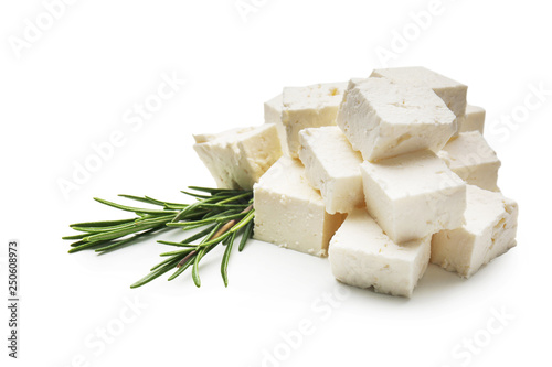 Pieces of tasty feta cheese on white background