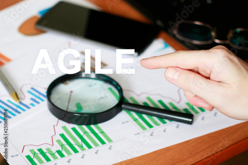 Agile Software Development Business on background of chart and search magnifier