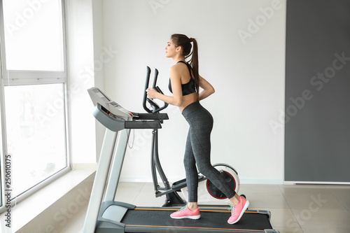 Sporty young woman on tread...