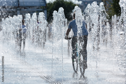 A man rides a Bicycle through a dry fountain on the Crimean embankment in Moscow