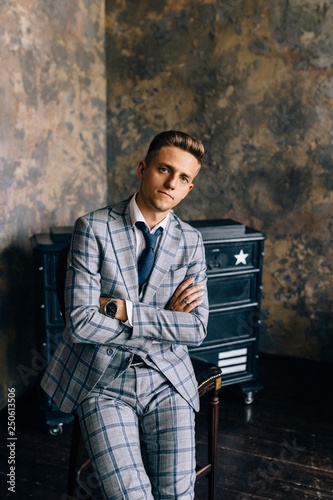 Foto A man in a blue suit is sitting on a chair