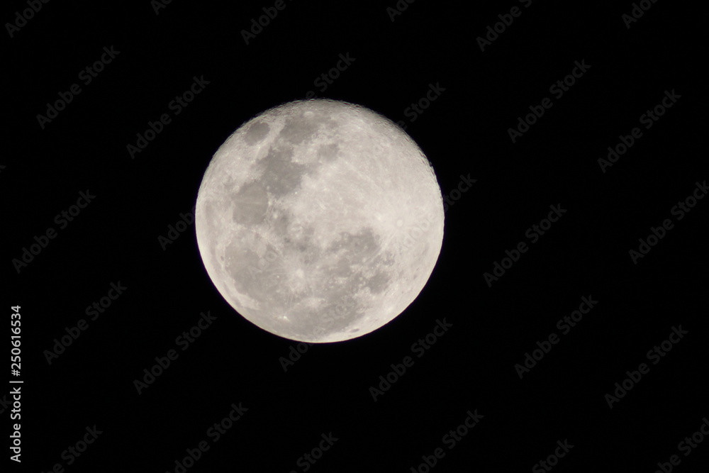 First moon after the full moon with distinct craters visible on the upper edge