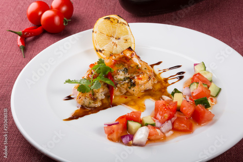 Grilled white fish fillet with vegetable salad