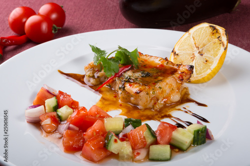 Grilled white fish fillet with vegetable salad