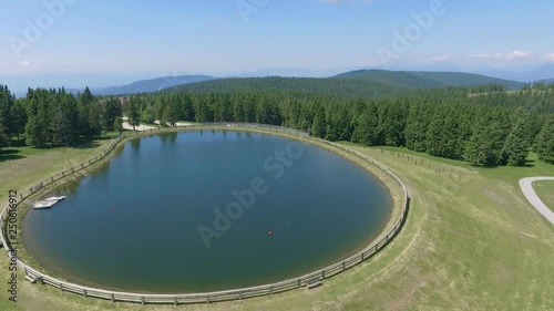 A beautiful round lake in the middle o nowhere. Aerial shot. It's a nice summer day. photo