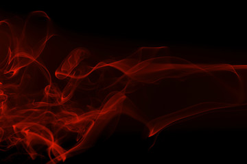 Movement of red smoke on black background