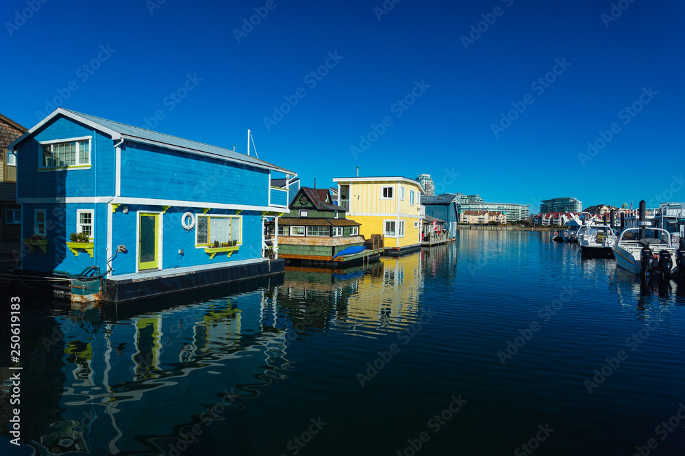 Colorful wooden floating houses on sunny summer day with blue sky. Colorful wooden floating houses on sunny summer day with blue sky.