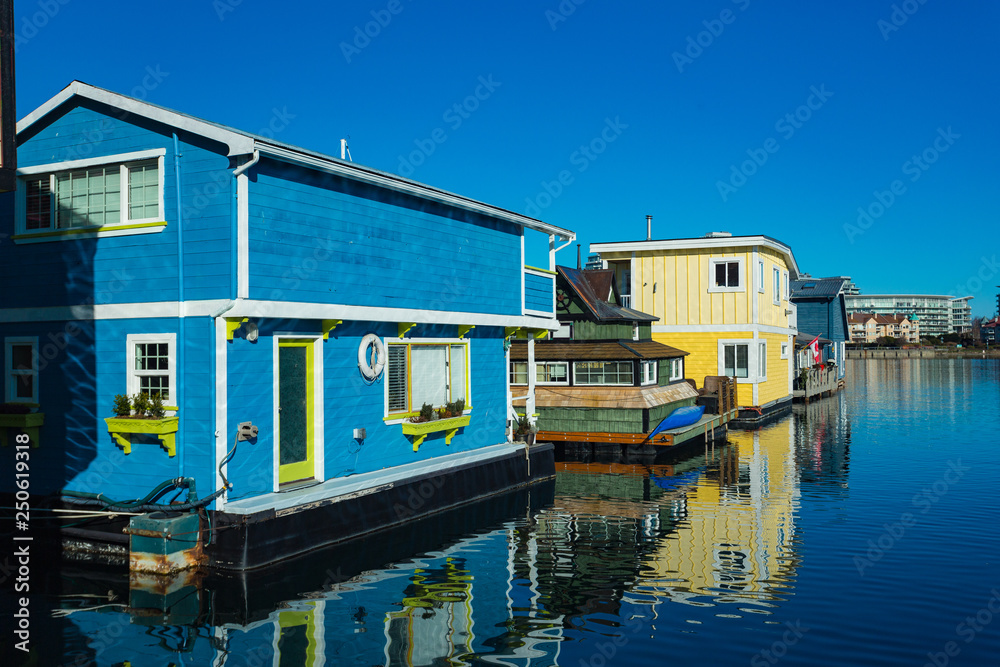 Colorful wooden floating houses on sunny summer day with blue sky.
