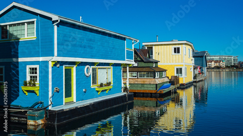 Colorful wooden floating houses on sunny summer day with blue sky.