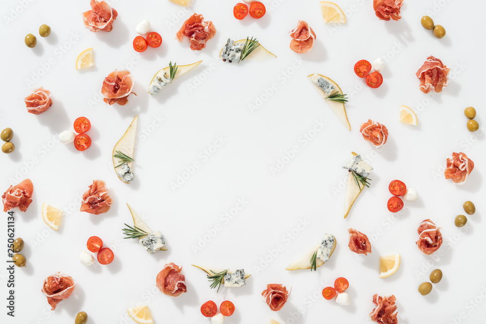 flat lay of sliced pears with blue cheese and rosemary twigs near prosciutto, and organic ingredients on white background flat lay of sliced pears with blue cheese and rosemary twigs near prosciutto, and organic ingredients on white background
