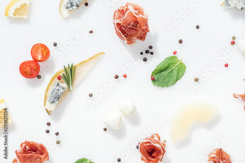 Fototapeta Naklejka Na Ścianę i Meble -  top view of tasty prosciutto near healthy ingredients and spices on white background