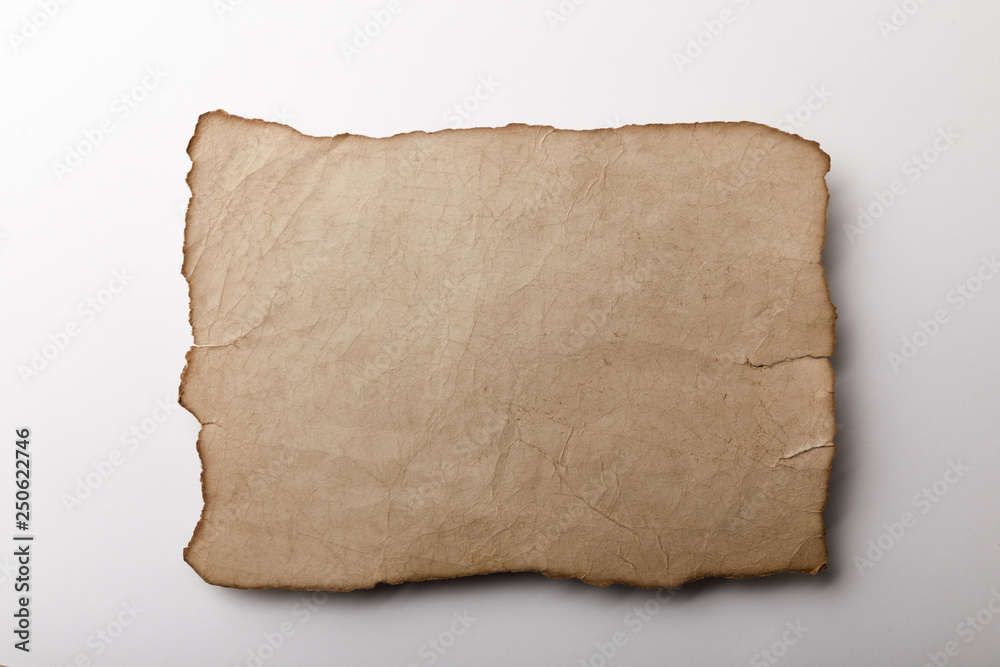 top view of old parchment sheet lying on white background