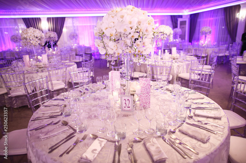 Indoor round reception table with flowers and chairs