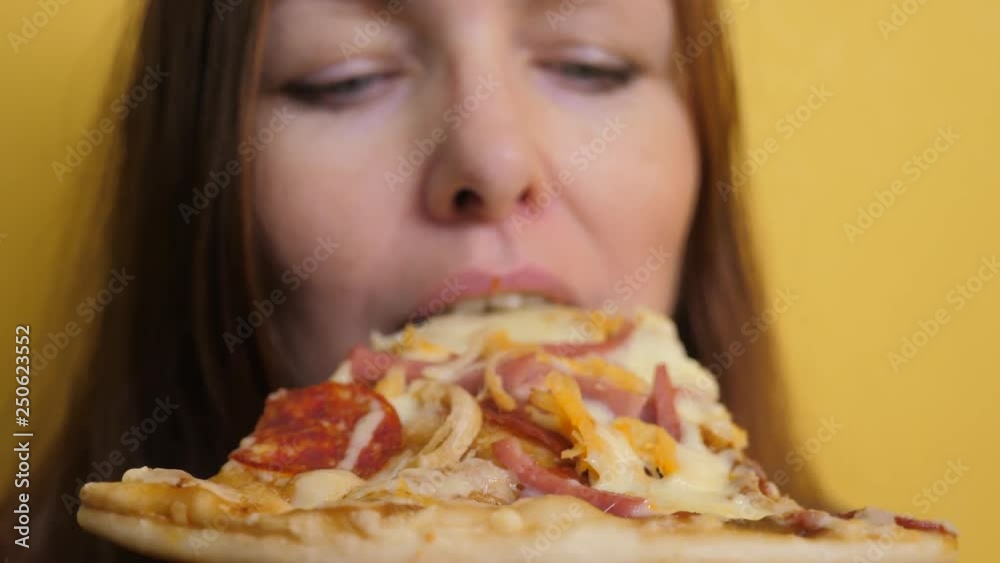 Piece Pizza . happy girl eating a slice of pizza concept . woman hungry eats a slice of pizza. slow motion video. pizza lifestyle fast food concept Piece Pizza . happy girl eating a slice of pizza concept . woman hungry eats a slice of pizza. slow motion video. pizza lifestyle fast food concept