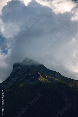 Peaks of Dombai mountains in summer rain clouds © dmitriydanilov62