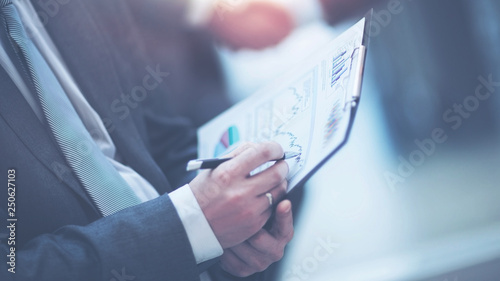 Close-up of female and male hands pointing to a business document while working with him