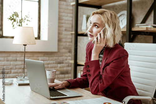 Φωτογραφία Unpleasant short-haired businesswoman rolling her eyes during conversation