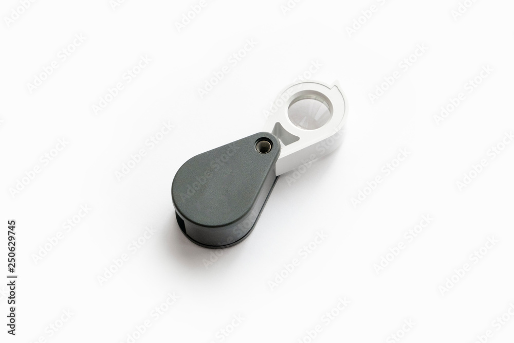 Magnifying glass for diamonds or see the amulet Isolated on a White Background. Magnifying glass for diamonds or see the amulet Isolated on a White Background.