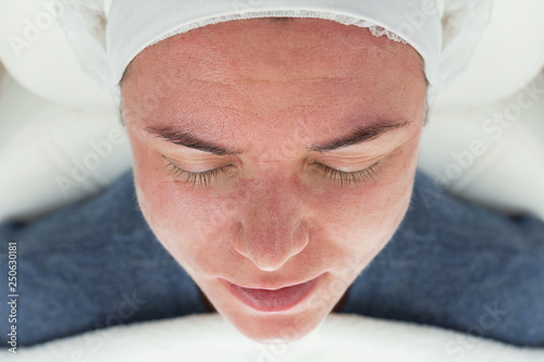 Close-up of Laser rejuvenating facial face treatment at cosmetology clinic. Young woman getting lifting anti-aging and skincare, laser polishing facial therapy, aesthetic cosmetology.