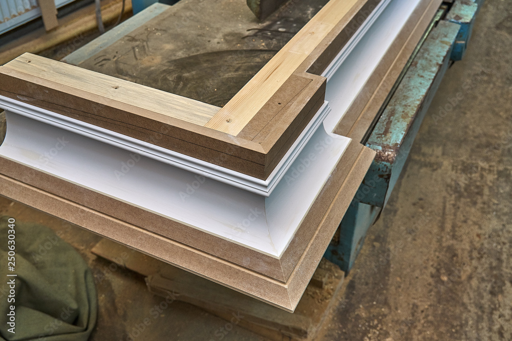 Crown molding. Home library with classic design. Wooden furniture manufacturing process Crown molding. Home library with classic design. Wooden furniture manufacturing process