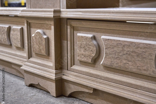 Mdf cabinet carcass with moldings and decor. Home library with classic design. Wooden furniture manufacturing process