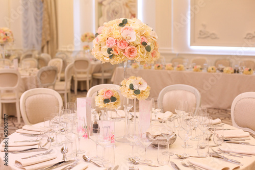 Elegant wedding reception table arrangement, floral centerpiece © hreniuca