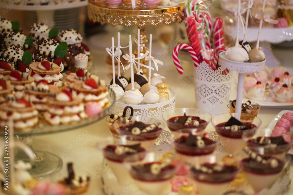 Delicious candy bar with macarons, cupcakes, cake pop and other sweets