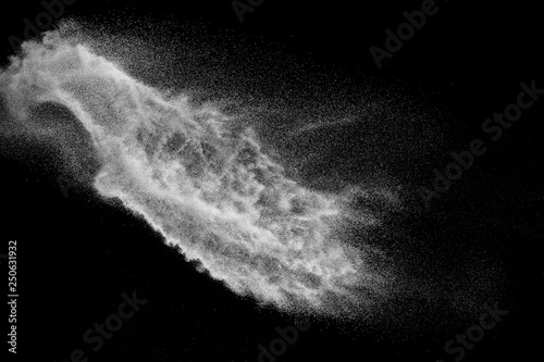 Bizarre forms of white powder explosion cloud against black background.White dust particles splash.