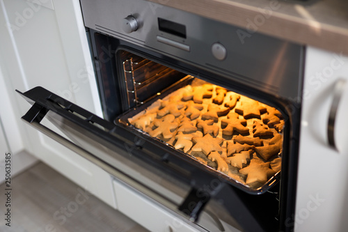 close up of cookies or gingerbreads in modern oven