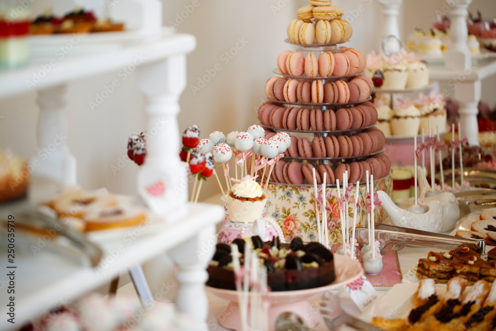 Delicious candy bar with macarons, cupcakes, cake pop and other sweets