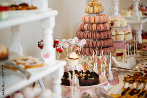 Delicious candy bar with macarons, cupcakes, cake pop and other sweets