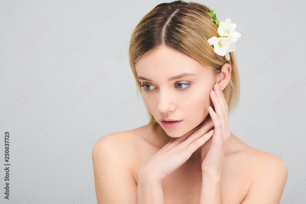 beautiful tender girl with clean face and freesia flowers in hair, isolated on grey beautiful tender girl with clean face and freesia flowers in hair, isolated on grey