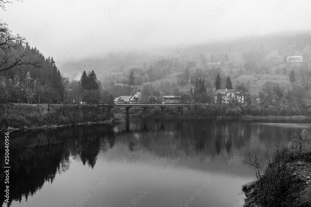 View of Elbe river and surrounding mountains - Giant Mountains (Krkonose). Small town of Spindleruv Mlyn and Labska village. Czech Republic. Black and white.