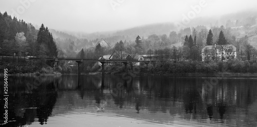 View of Elbe river and surrounding mountains - Giant Mountains (Krkonose). Small town of Spindleruv Mlyn and Labska village. Czech Republic. Black and white.